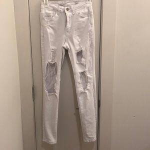 Distressed white skinny jeans